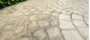 Pros and Cons of Stamped Concrete vs Pavers Around Your Pool